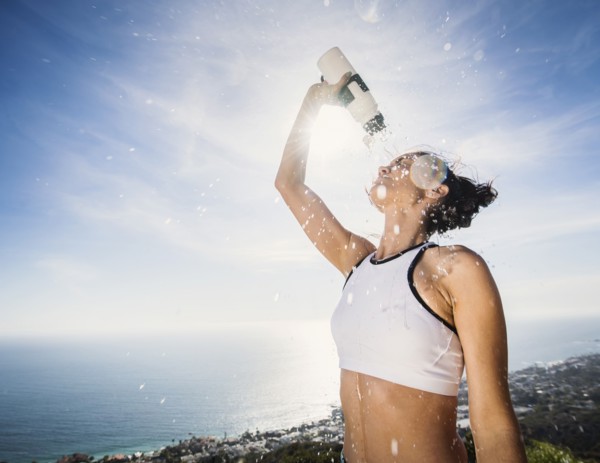 Woman pouring water on her head