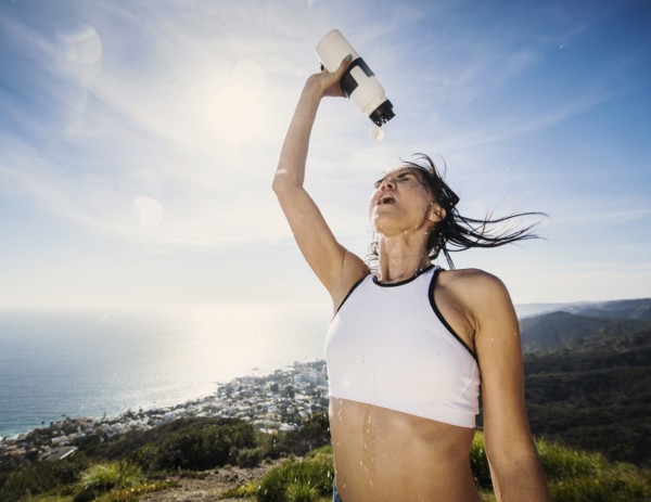 Woman pouring water on her head