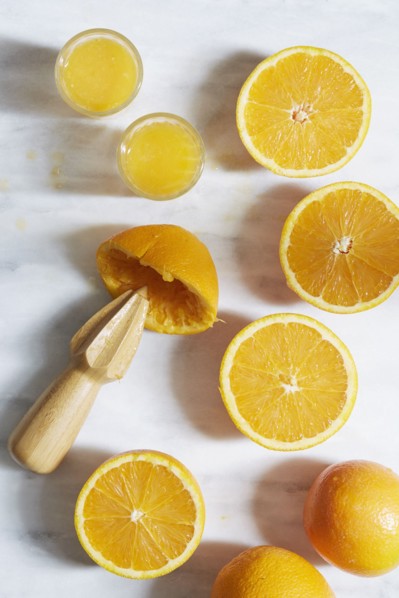 Sliced oranges with juicer