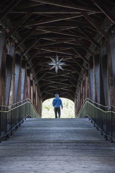 Man on covered bridge