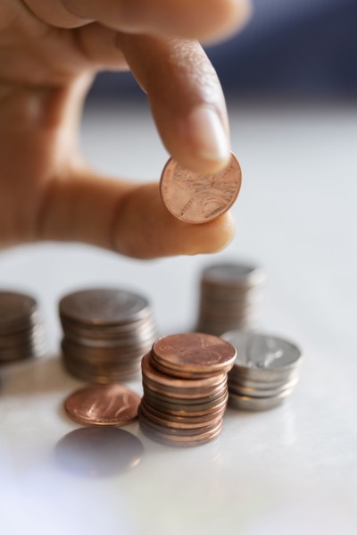 Hand of woman stacking coins