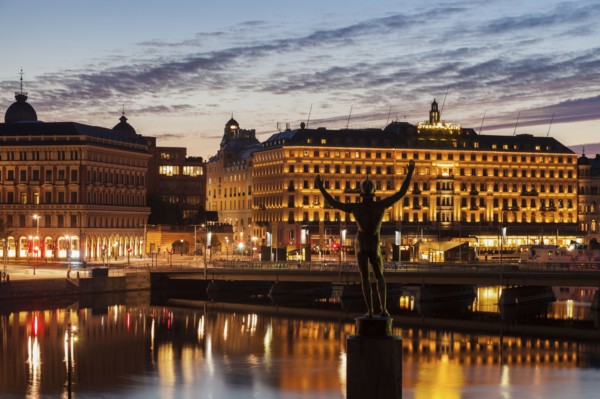 Statue by buildings at sunset in Stockholm, Sweden