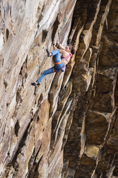 Teenage girl rock climbing