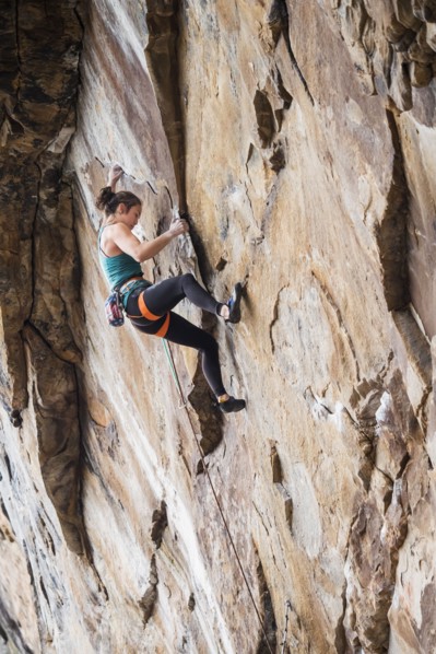 Teenage girl rock climbing
