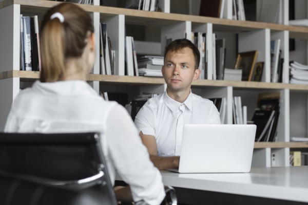 Businessman conducting job interview with young woman