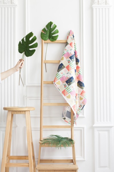 Fabric on rack with palm leaves
