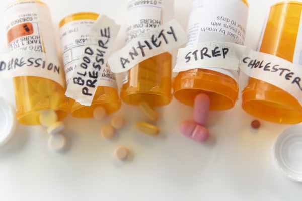 Spilled pill bottles labelled with ailments