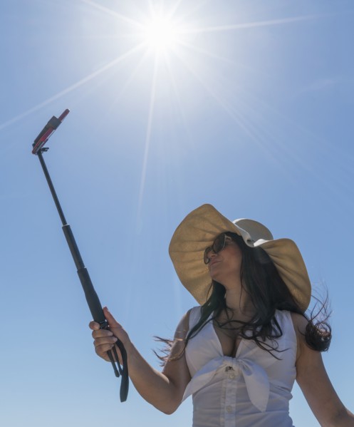 Low angle shot of woman using selfie stick