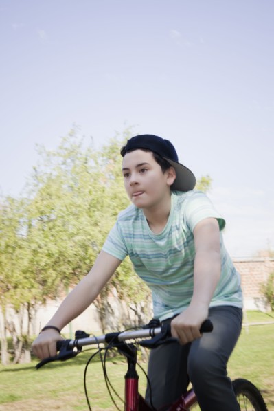 Teenage boy cycling in park