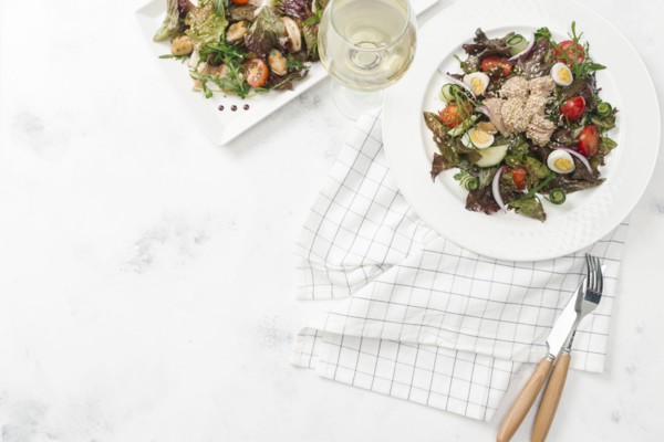 Plate of salad with white wine