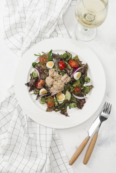 Plate of salad with white wine