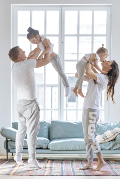 Parent lifting daughters by window