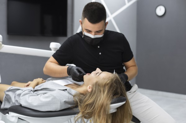 Dentist examining patient