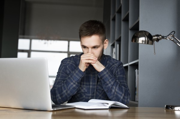 Young businessman looking at laptop