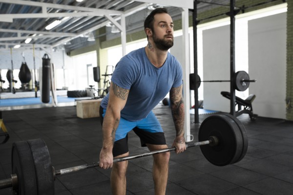 Mid adult man weight lifting in gym