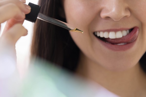 Woman with pipette of essential oil