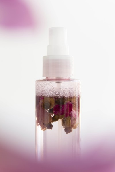 Skin care spray bottle with flowers inside