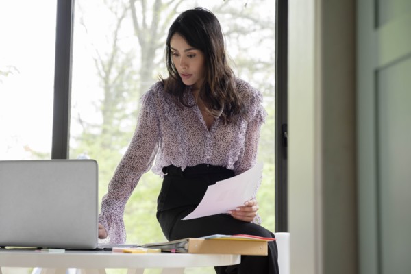 Businesswoman using laptop in office