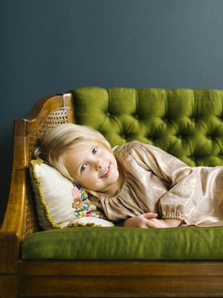 Girl  lying on green sofa