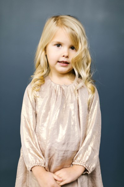Girl wearing taupe dress