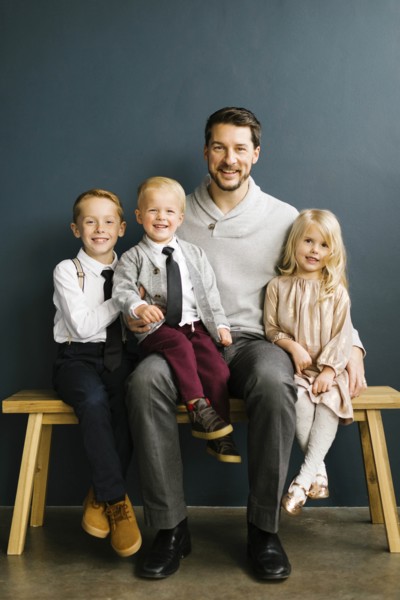 Father sitting with his three children