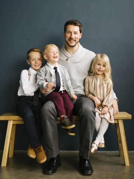 Father sitting with his three children