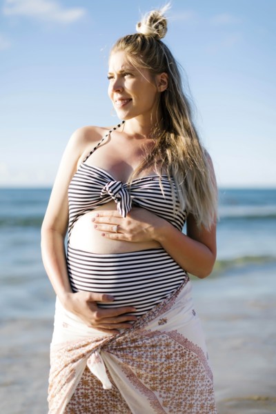 Pregnant woman on beach