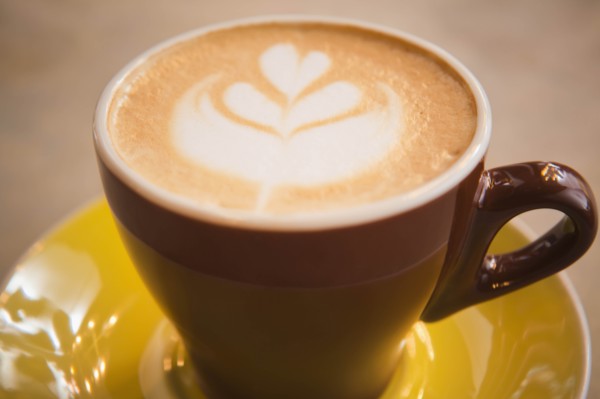 Coffee in yellow cup with heart shape