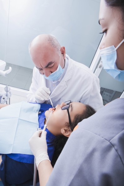 Teenage girl getting dental cleaning