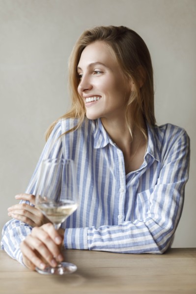 Young woman with glass of white wine