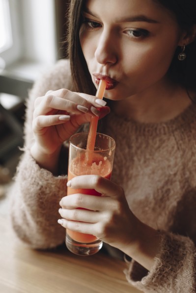 Young woman drinking juice