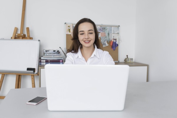 Fashion designer working at laptop