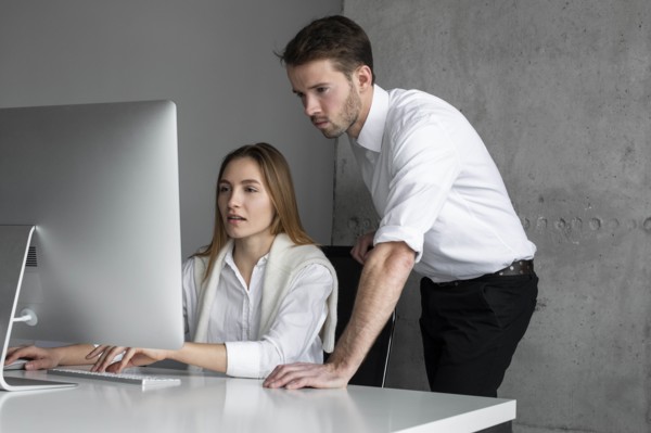 Businesspeople using computer together
