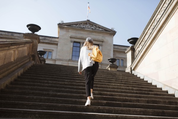 Young woman walking on steps in Berlin, Germany