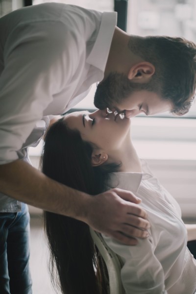 Young couple face to face with their eyes closed