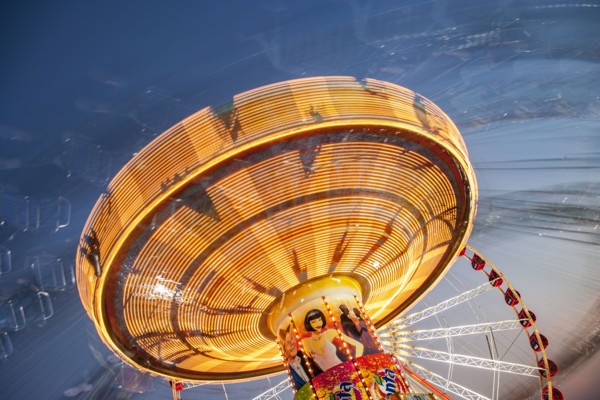 Long exposure of illuminated chain swing ride
