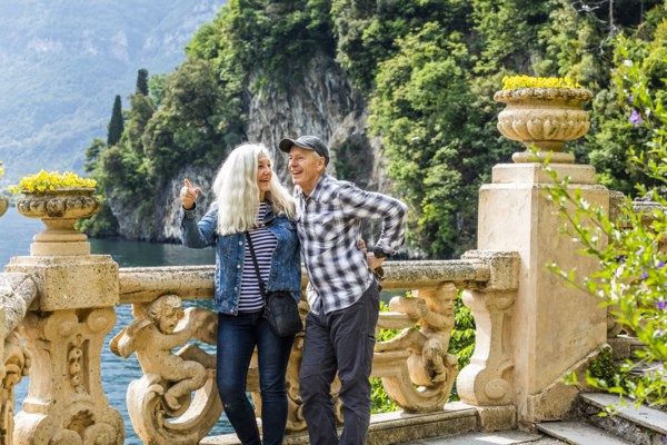 Smiling couple at Villa del Balbianello by Lake Como, Italy