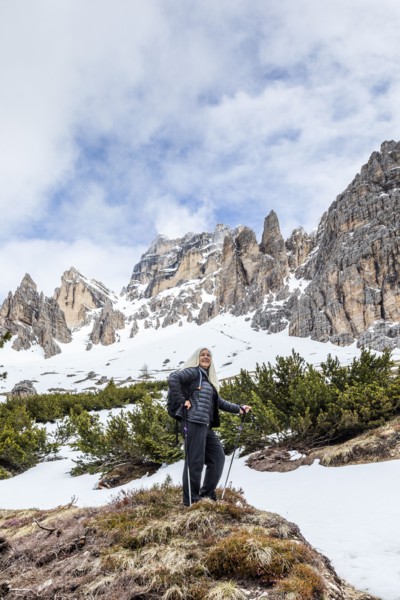 Woman hiking on Giau Pass in Dolomites, Italy