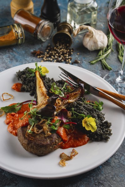 Meal of beef with vegetables and flowers