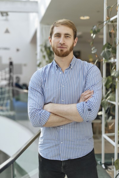 Man wearing striped shirt with his arms crossed