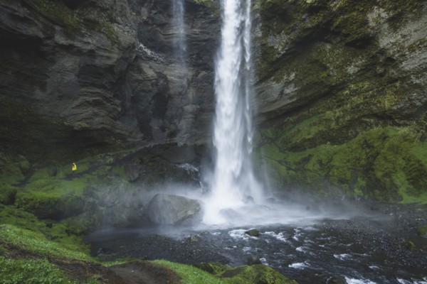 Woman by Kvernufoss waterfall in Iceland