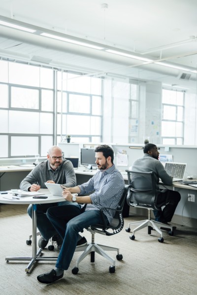 Men using digital tablet during meeting in office