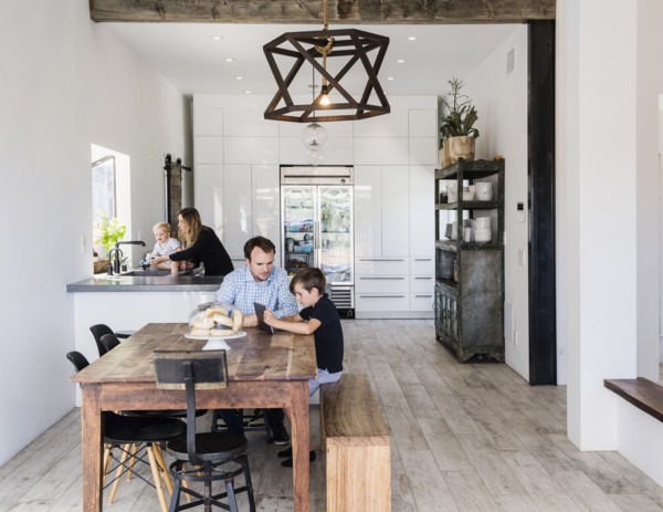 Father and son using digital tablet at dining table