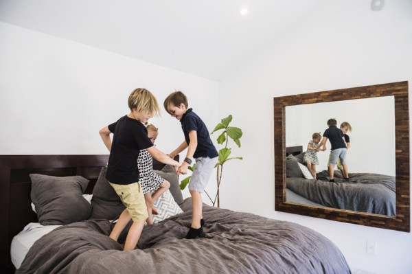 Children jumping on bed