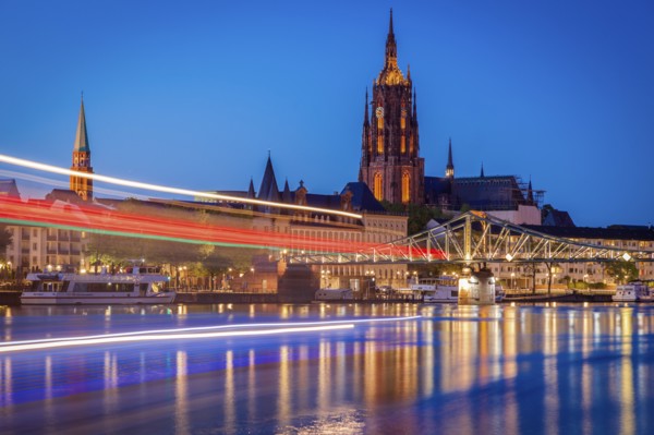 Light trails on river at sunset in Frankfurt