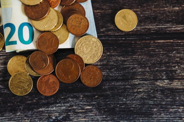 Euro coins on twenty Euro note