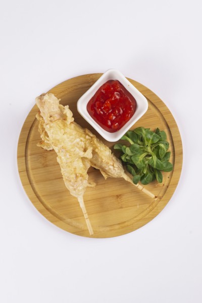 Deep fried sausages on skewers with tomato sauce