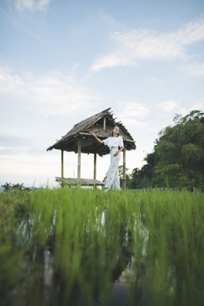 Woman walking in rice paddy in Bali