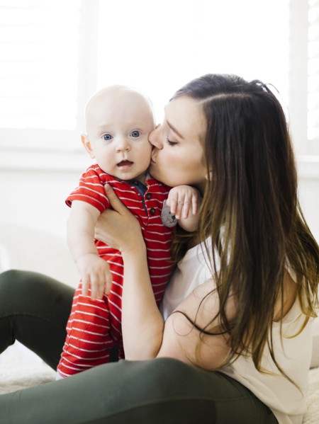 Woman kissing her baby boy's cheek