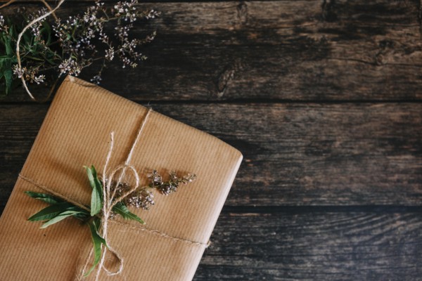 Present wrapped in brown paper with string and flowers